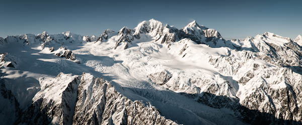 Fox Glacier under highest peaks in New Zealand - Mt. Tasman 3,497m and Mt Cook 3,754m